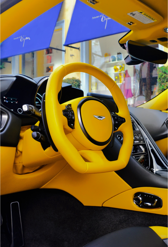 the interior of a yellow and black sports car