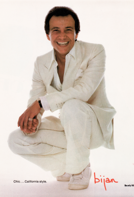 a man in a white suit and white sneakers