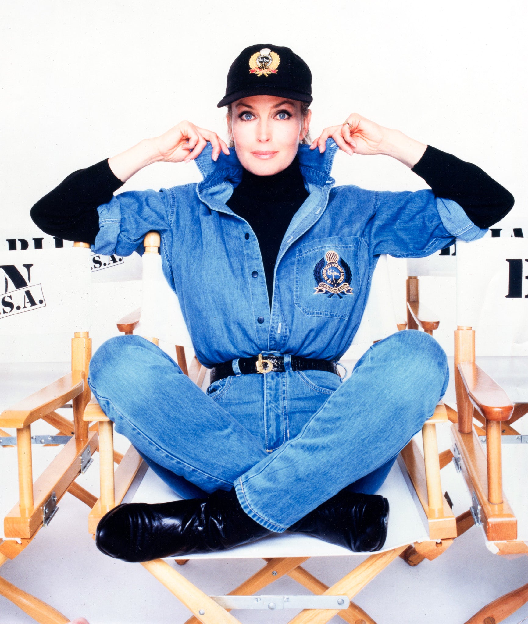 a woman sitting on top of a wooden chair