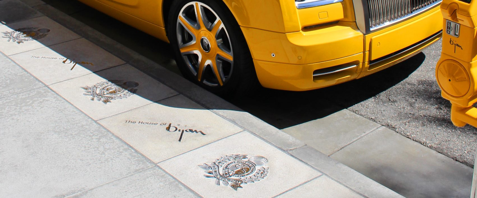 a yellow car parked on the side of the road