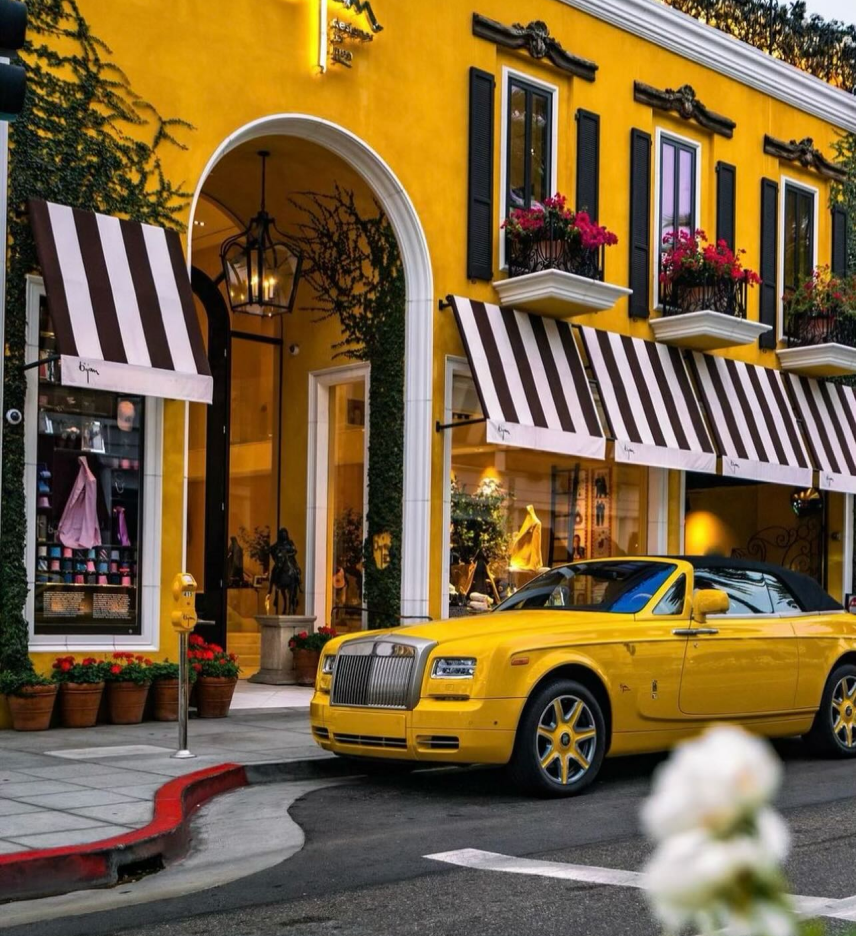 a yellow car parked in front of a yellow building