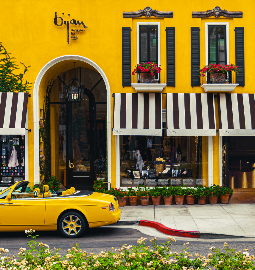 a yellow car parked in front of a yellow building