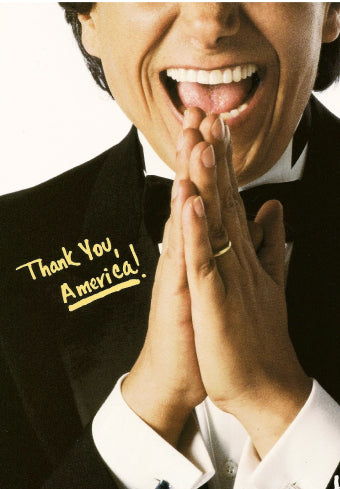 a man in a tuxedo with his hands together