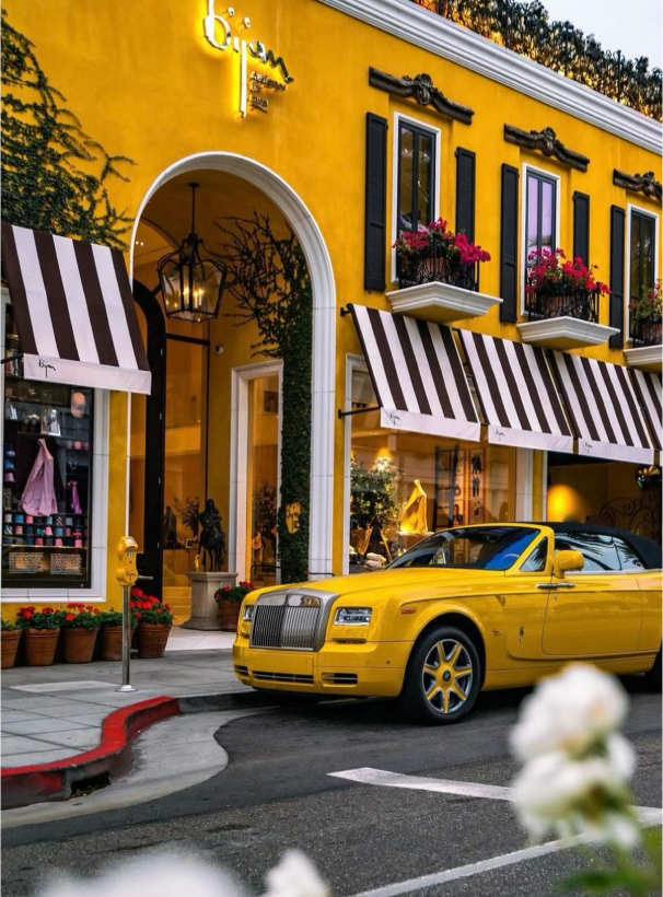 a yellow car parked in front of a yellow building