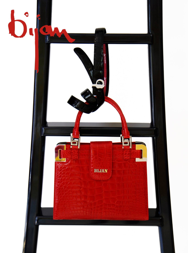 a ladder with a red handbag hanging from it